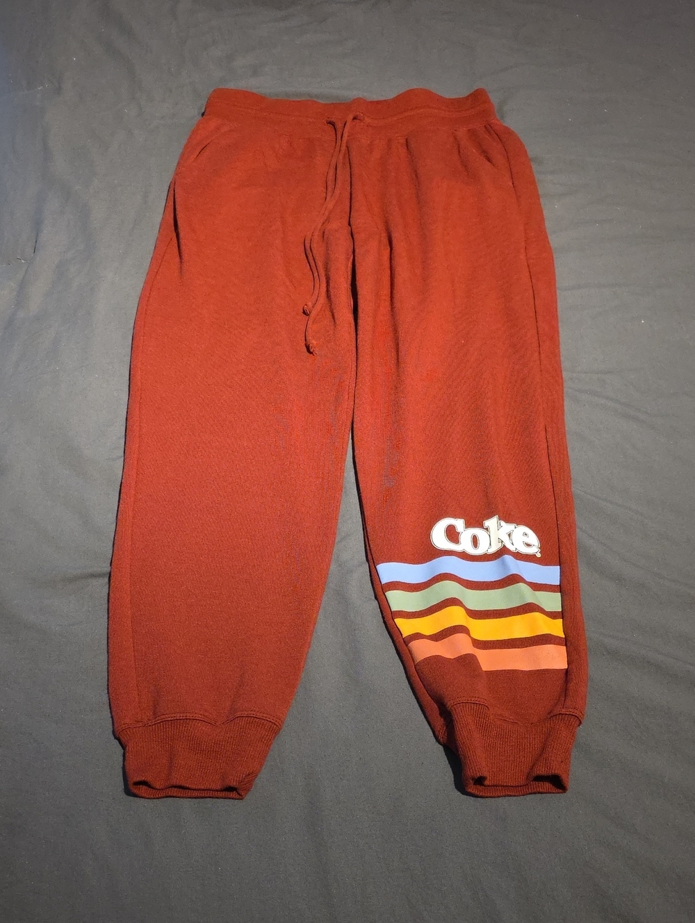 Coca-Cola Rust Red Jogger Pants with Multicolor Wave Stripes